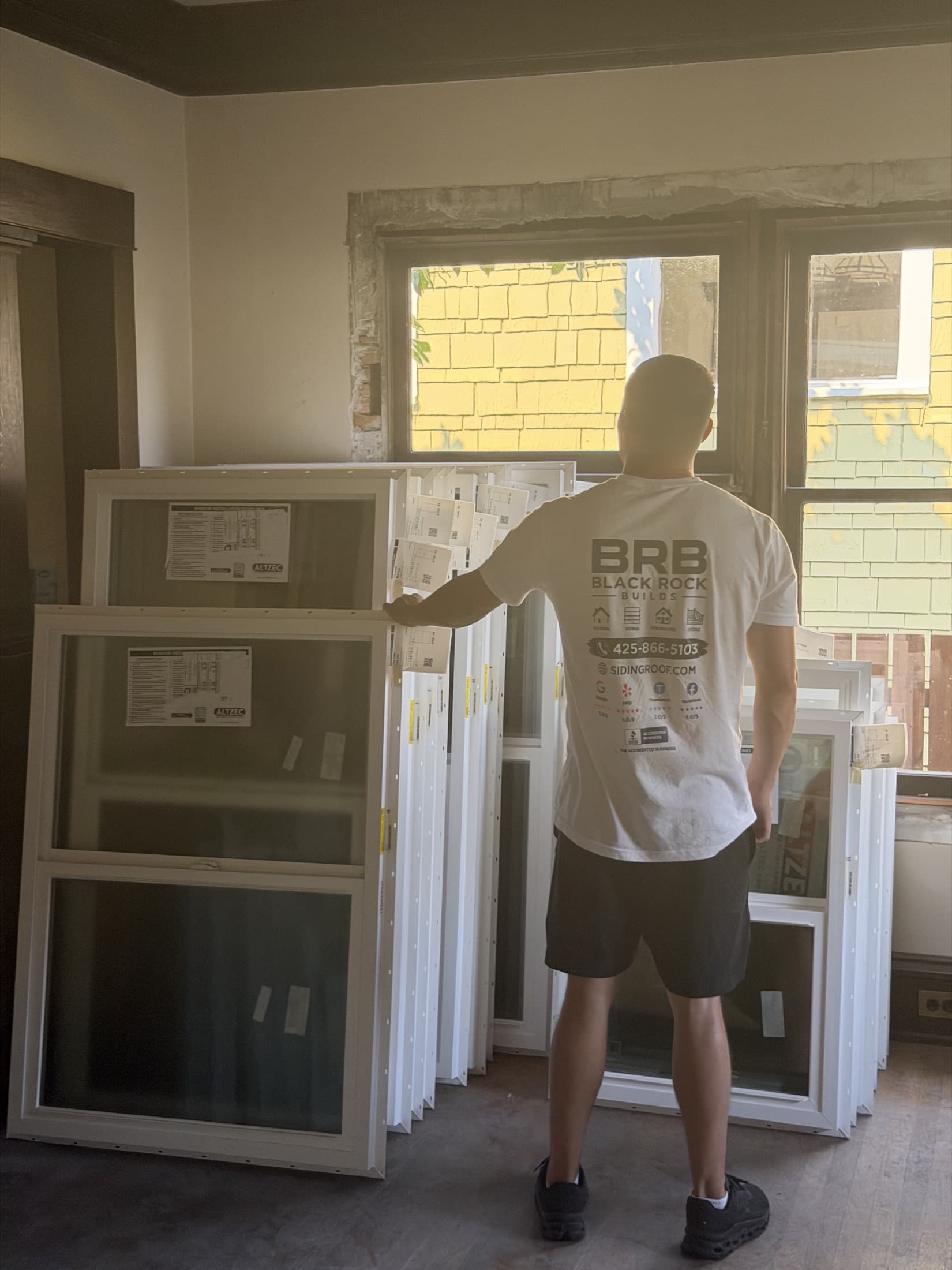 New replacement windows staged inside a home before installation